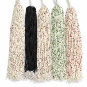 Long strands of edible sugar beads in white, black, and white with red and green accents for cake and sweet decoration.