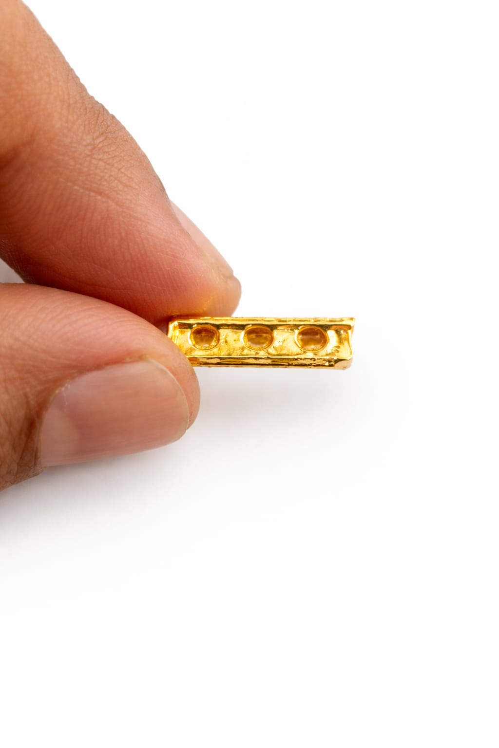 This gold plated rectangular pendant base connector is perfect for jewellery making and DIY designs. It features a flat tray-style surface, ideal for setting stones, resin art, kundan, or embellishments. The attached loop makes it easy to connect with chains, hooks, or jump rings. Its premium finish gives a rich and elegant look, making it suitable for creating pendants, earrings, and customized jewellery pieces. Durable and lightweight, it is a must-have for jewellery designers.